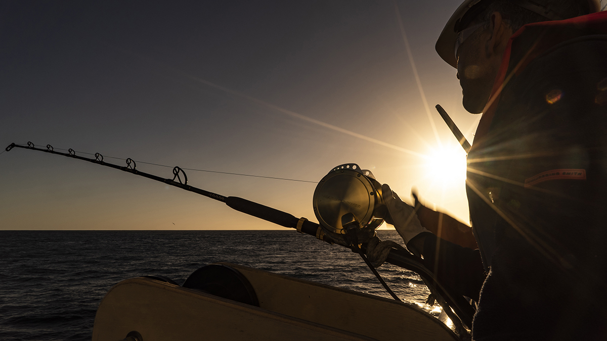 Silhouette of a man fishing