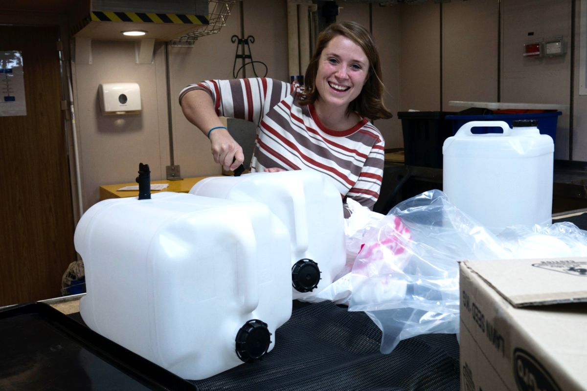 Jasmine Bursic of Melbourne Museum unpacking gear in one of the labs