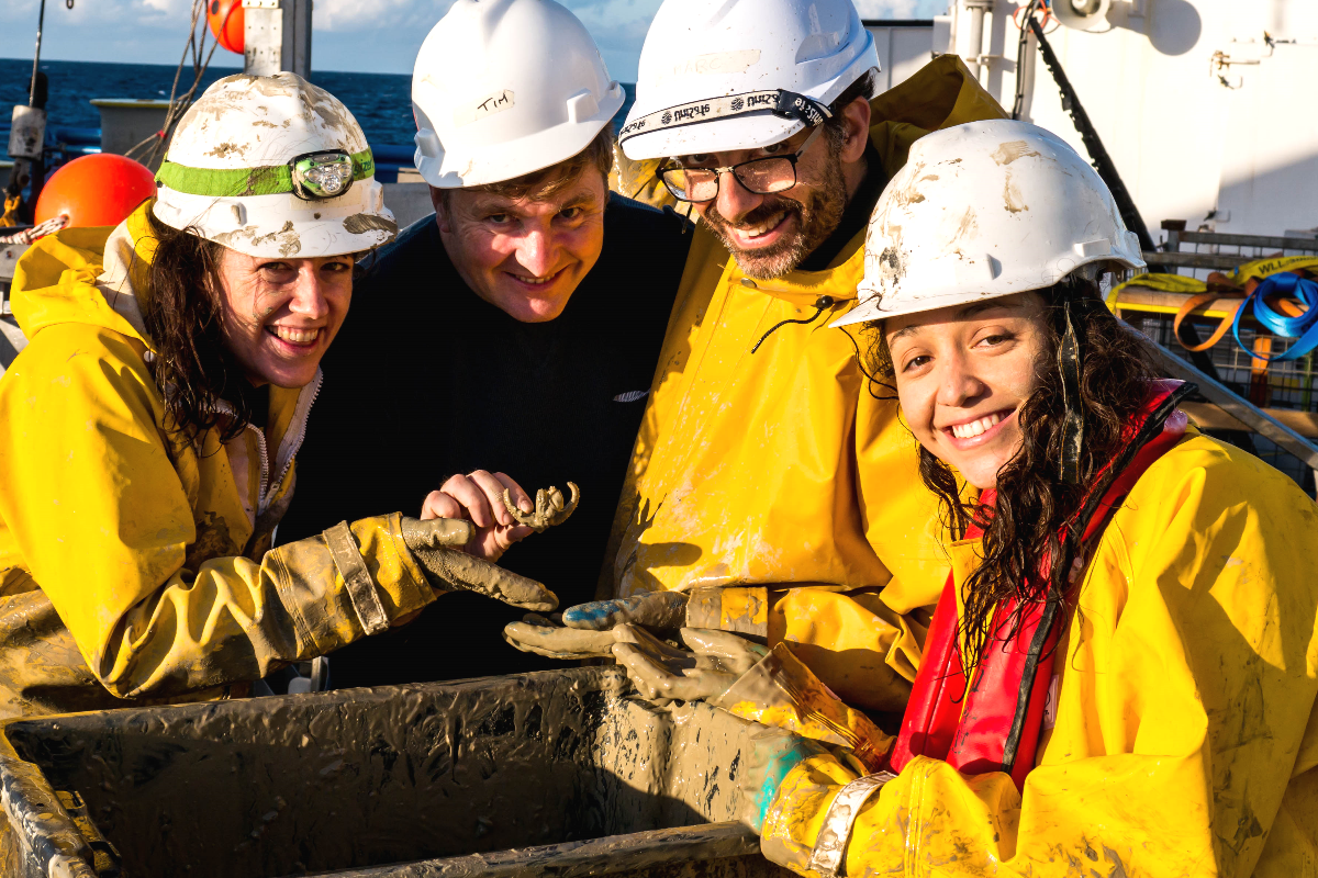 Scientists covered in abyssal mud