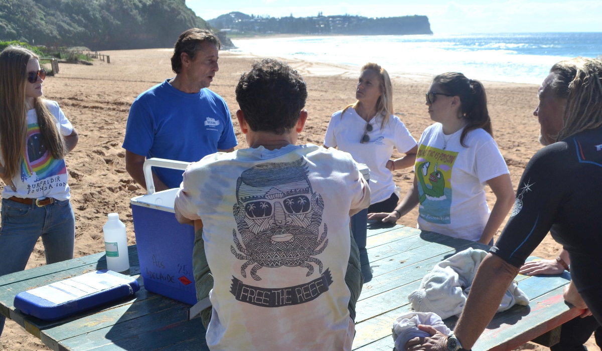 John Gemmill with surfers at a Sydney beach