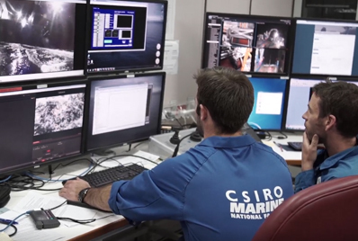 Technicians watch the camera system descend