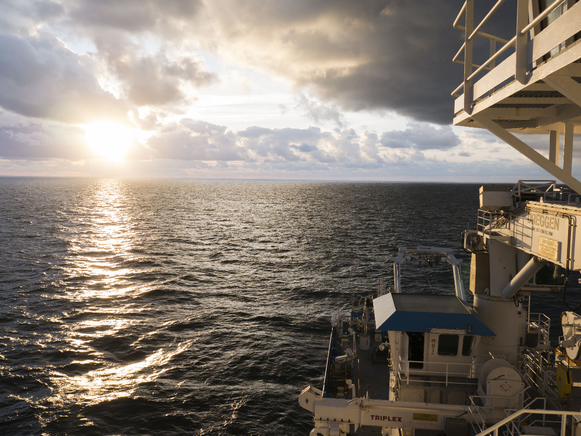 Sunset reflected on the RV Investigator at sea