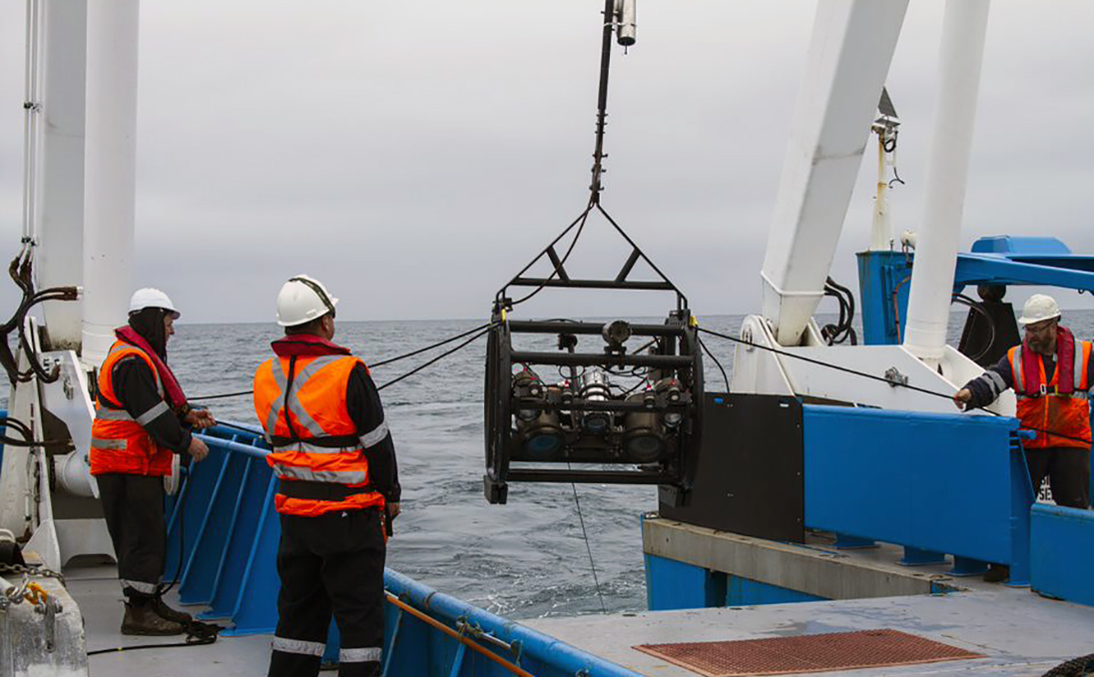 Crew members deploy the deep-tow camera