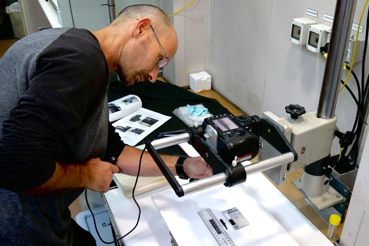 A scientist photographs one of the first fish sampled on the voyage.