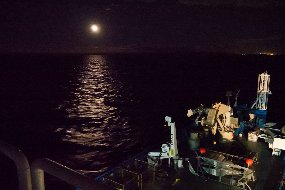 The RV Investigator heads out at night from Bell Bay Port.